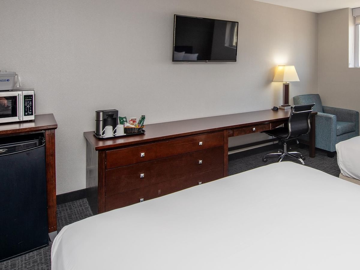 Two queens room with desk and TV.