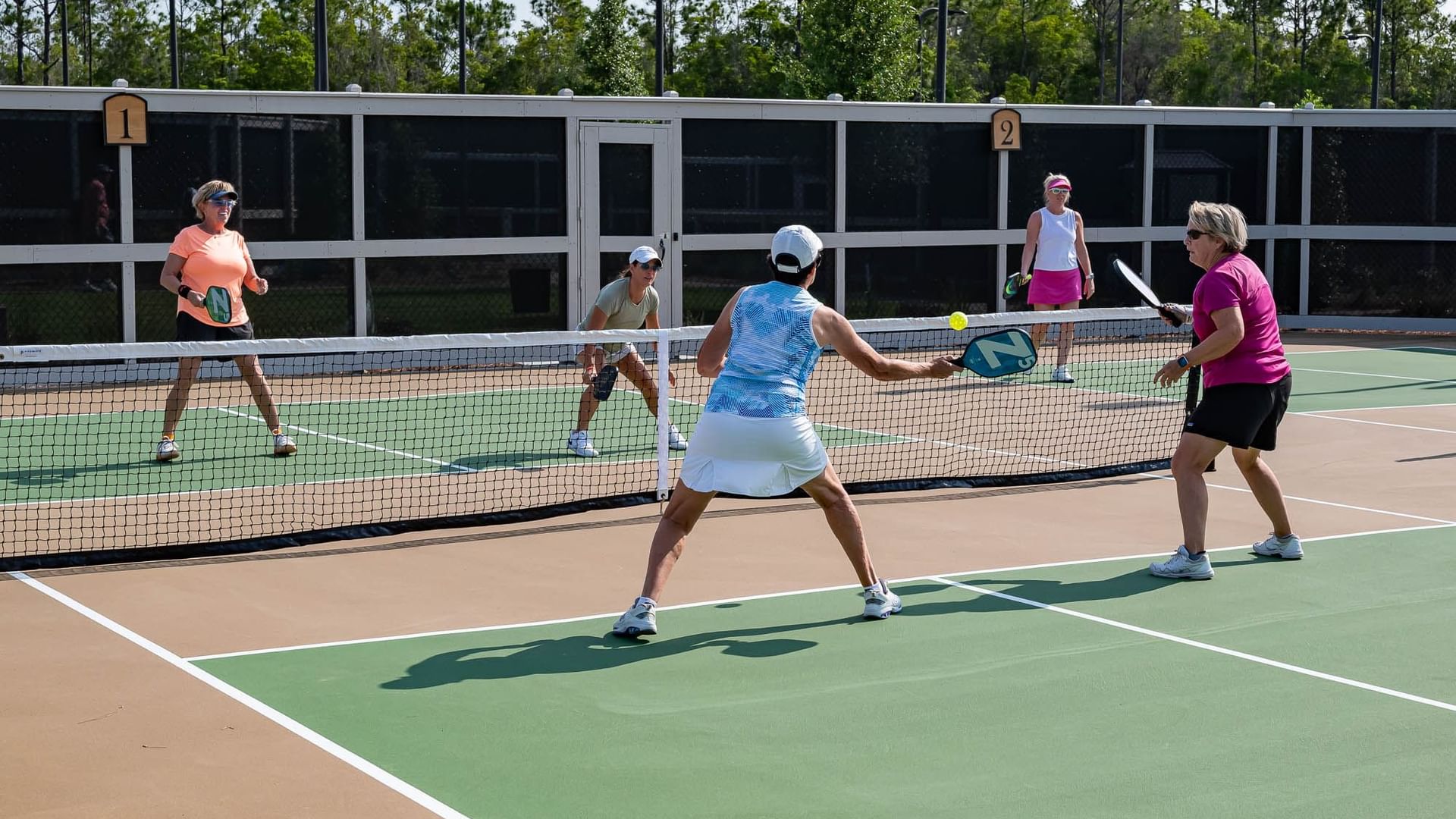 Camp Creek Inn guests enjoying a doubles pickleball game