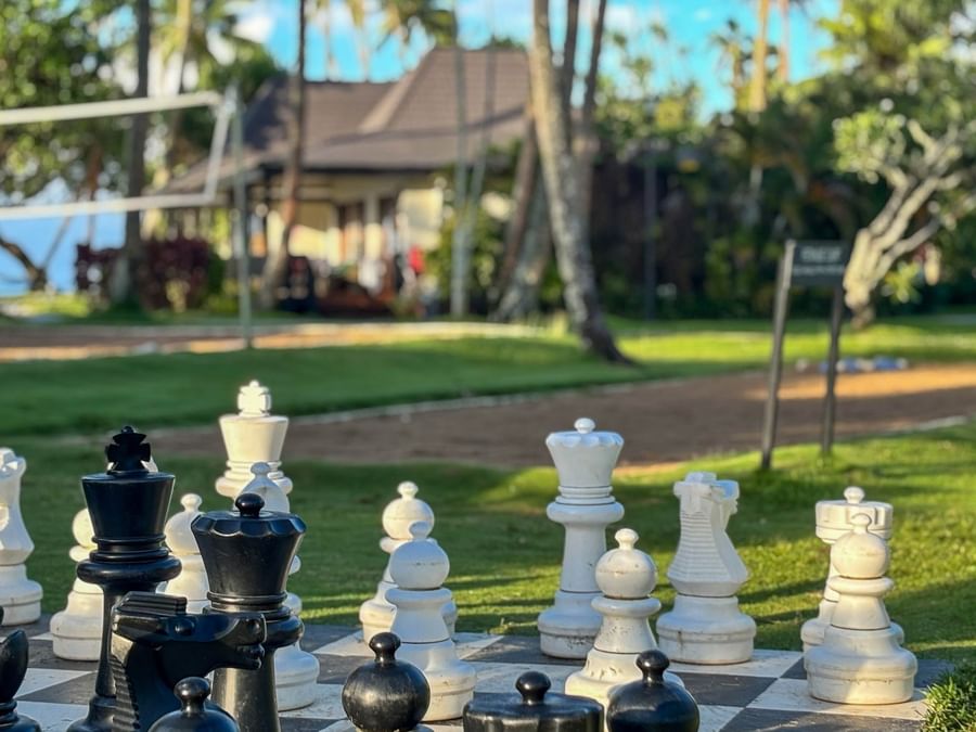 Chess set arranged on a board outdoors at The Naviti Resort Fiji.