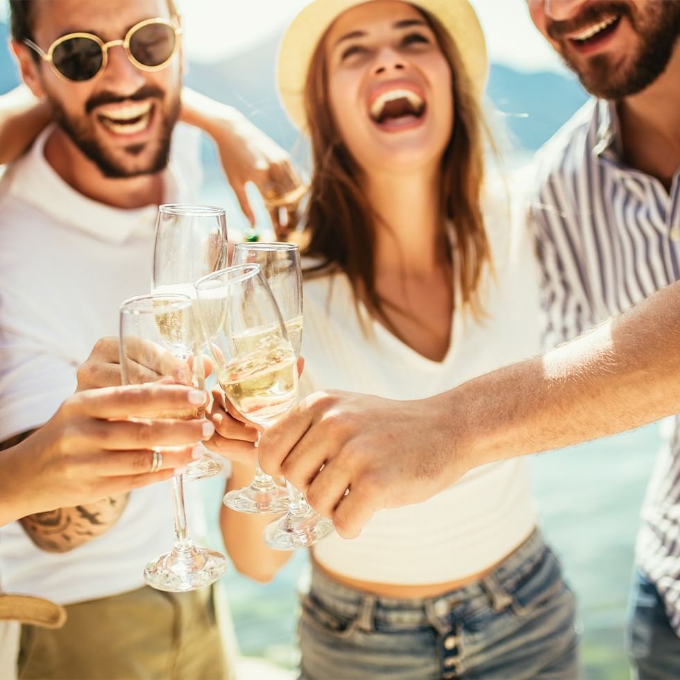 A group of friends cheers with champagne glasses, creating a joyful atmosphere.