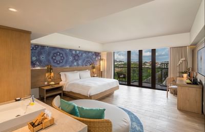 Comfy bed & city view from the Executive Room at Eastin Ashta Resort Canggu