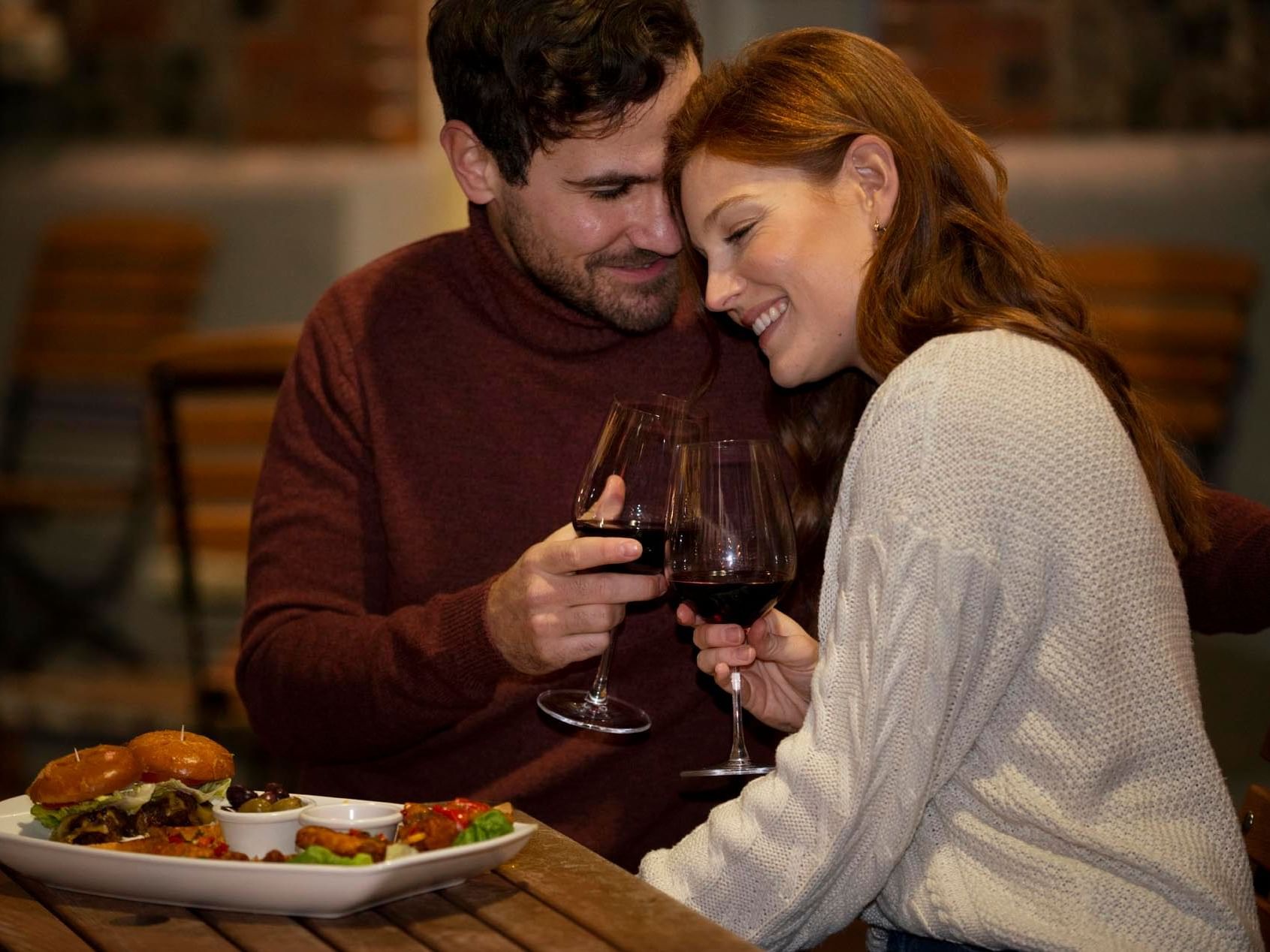 Couple toasting wine in Restaurant at 3C Hotels