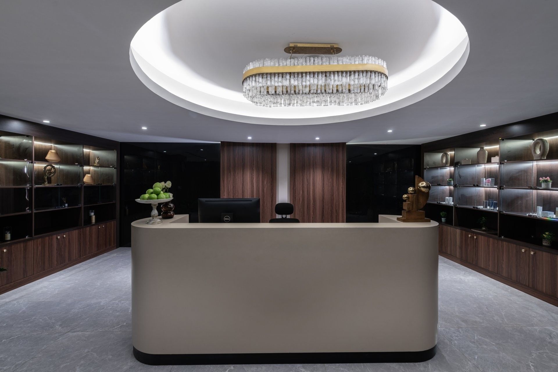 Reception counter by display shelves under a tiered crystal chandelier in Golden Time Spa at Warwick Al Taif Hotel