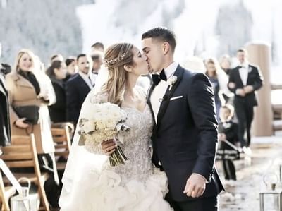 Wedded Couple posing outdoors in at Stein Eriksen Lodge