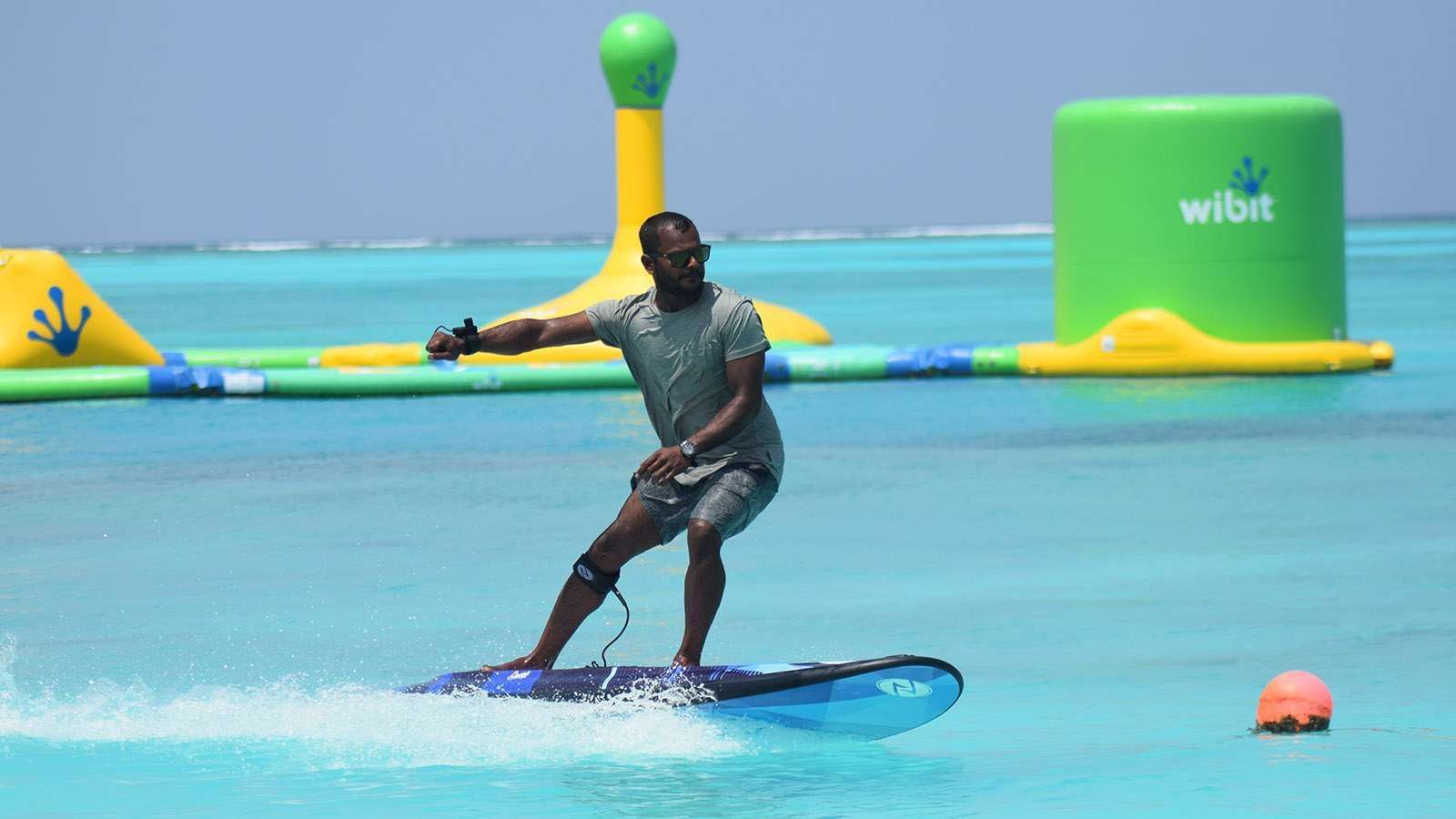 A surfer on E-surfing in the sea near The Signature Collection