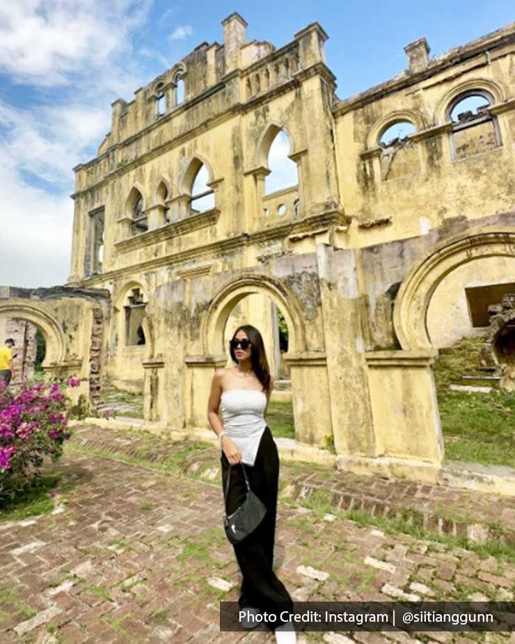 A woman was striking a pose and taking a picture inside Kellie's Castle - Lexis Suites Penang