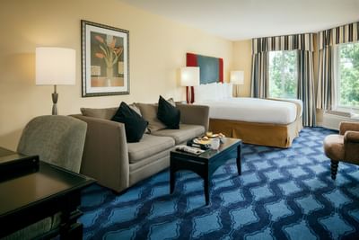 Executive King Creek-View with king bed and sitting area of Plaza Inn & Suites at Ashland Creek​