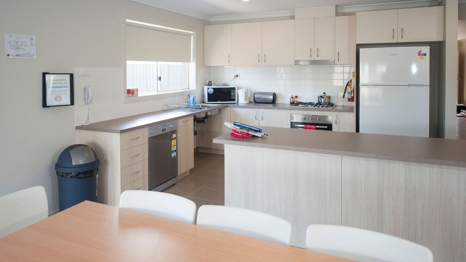 Modern kitchen with dining area and appliances at La Trobe University Regional Housing – Shepparton.