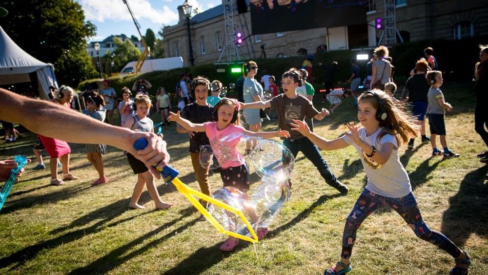 Children playing with bubbles at taste of summer festival near Hotel Grand Chancellor Hobart