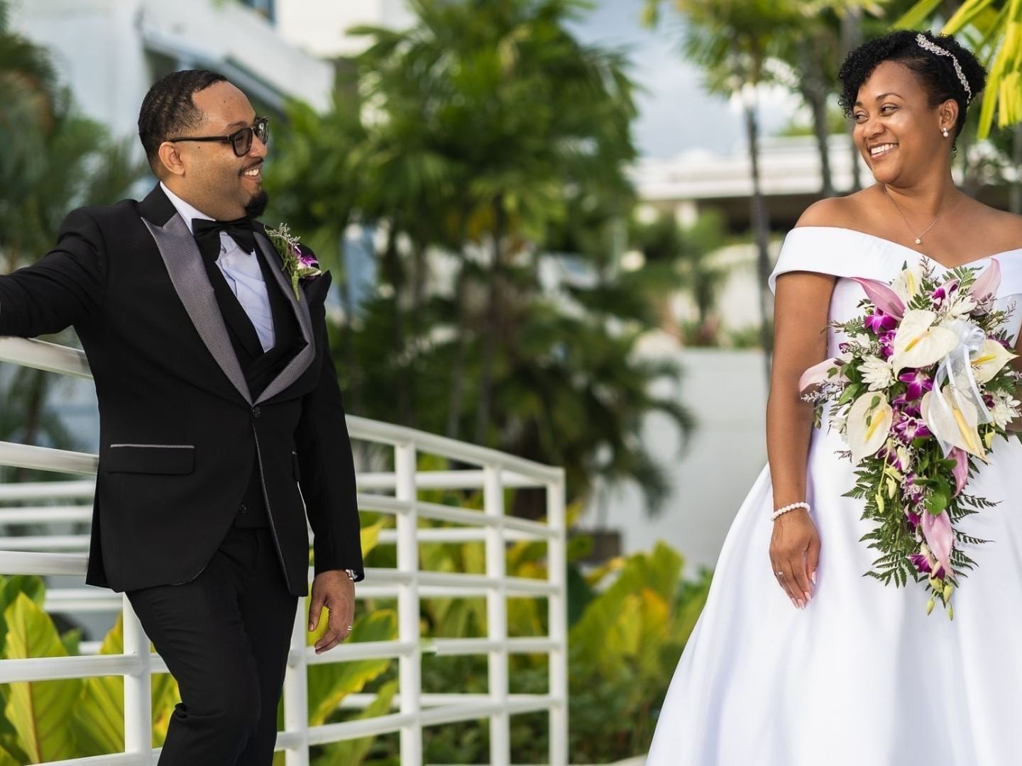 Newlyweds walking by the pool at Savannah Beach Hotel.