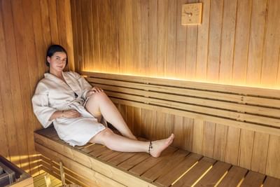 Lady relaxing in a Sauna at Diez Hotel Categoría