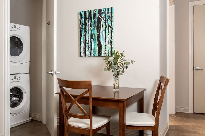 Table set-up with washer and dryer in Executive Residences 201 at Retro Suites Hotel