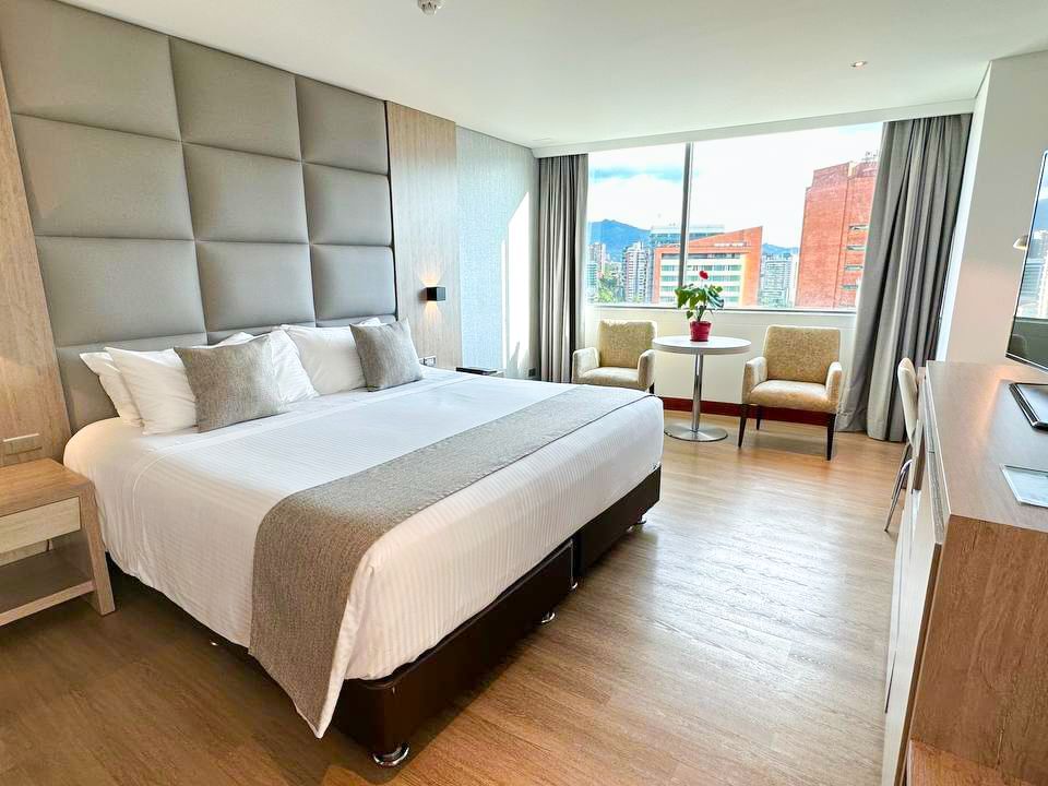 Spacious Grand Suite with bed and TV area at San Fernando Plaza Hotel