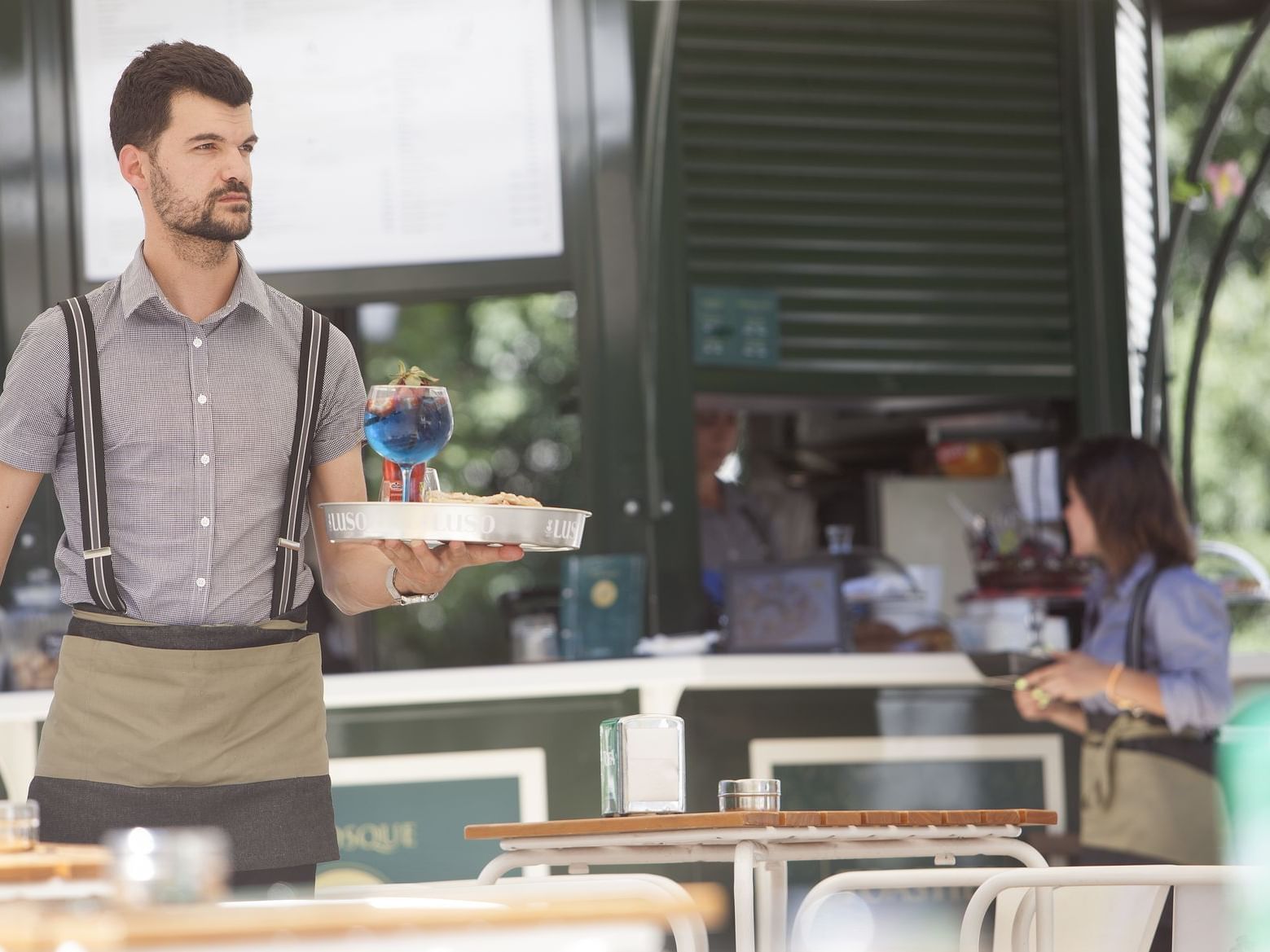 server carrying tray with drinks and food