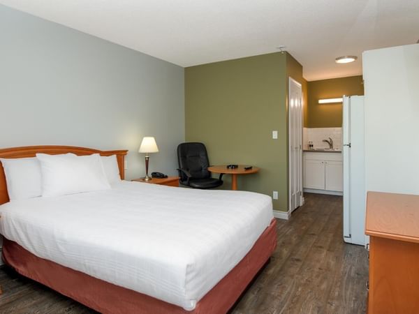 Guest room at Coast Red Deer Hotel with queen bed and kitchenette