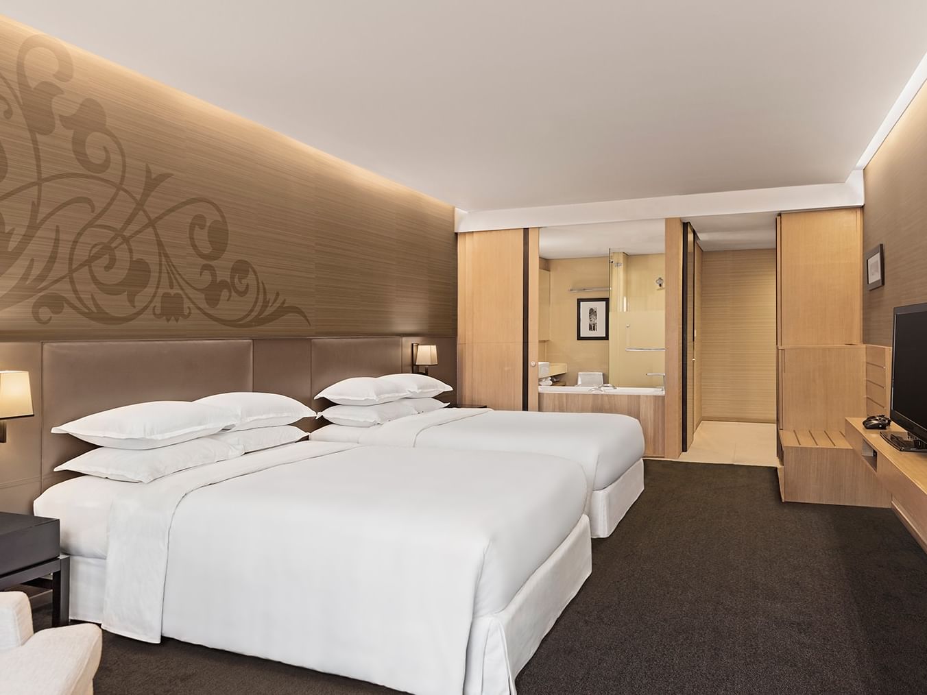 Premier Two Queen at Paradox Bangkok Sukhumvit, twin beds by a luggage rack under a floral wall mural near the bathtub