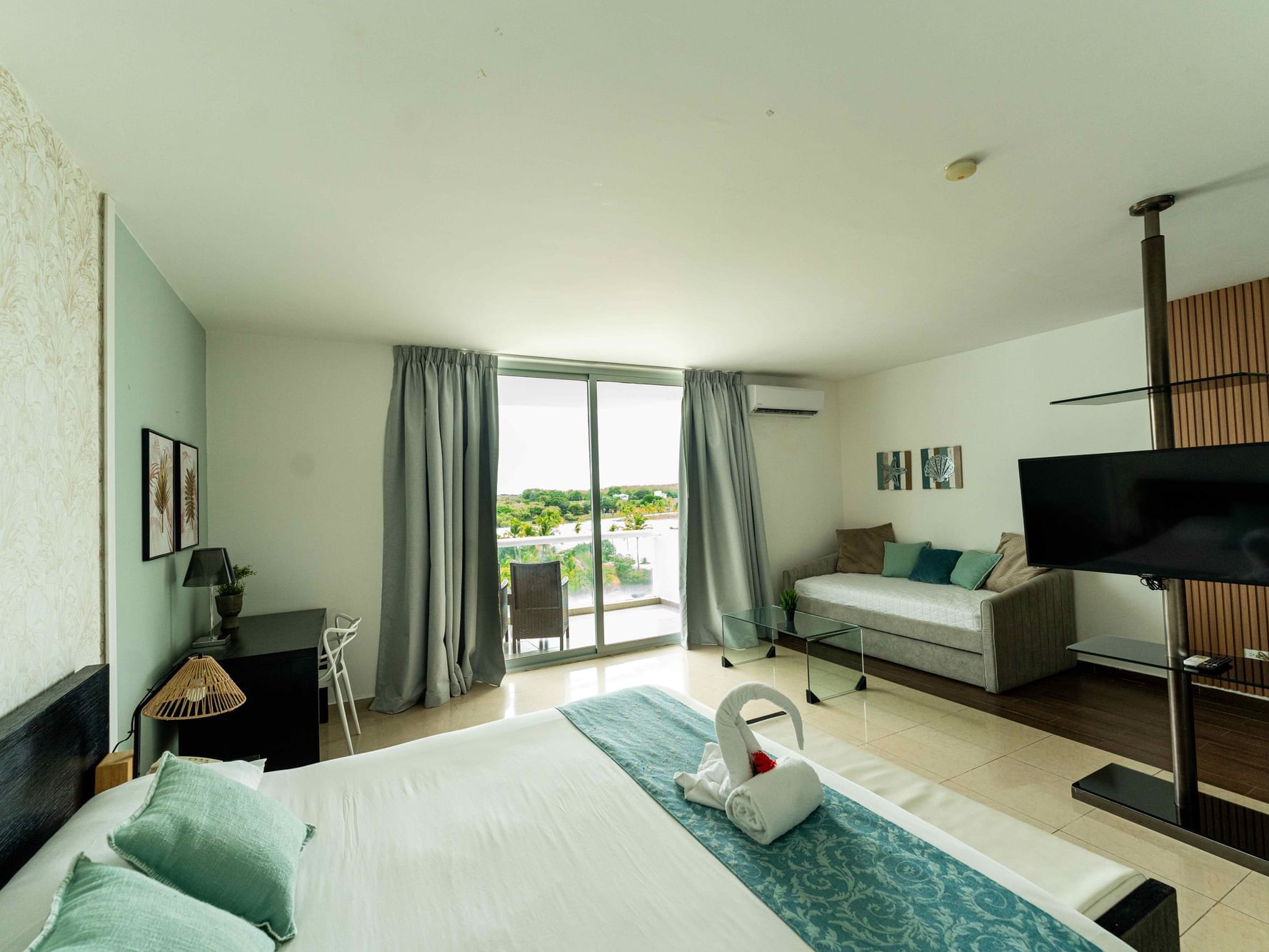 Luxury Suite with one king bed and sliding doors to a balcony with a pool view at Playa Blanca Beach Resort