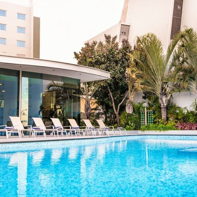 Outdoor pool with sunbeds at Crown Promenade Perth