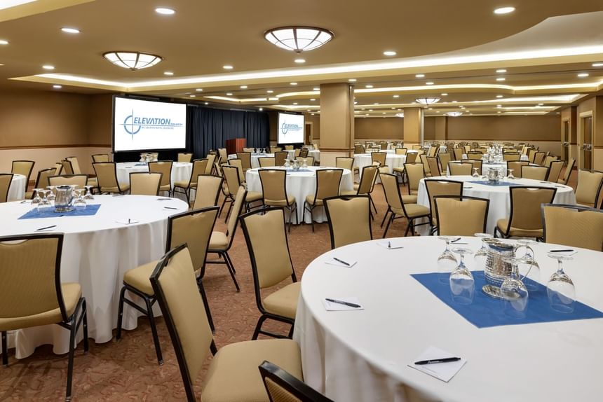 A conference room with round tables and chairs at Elevation Resort and Spa.