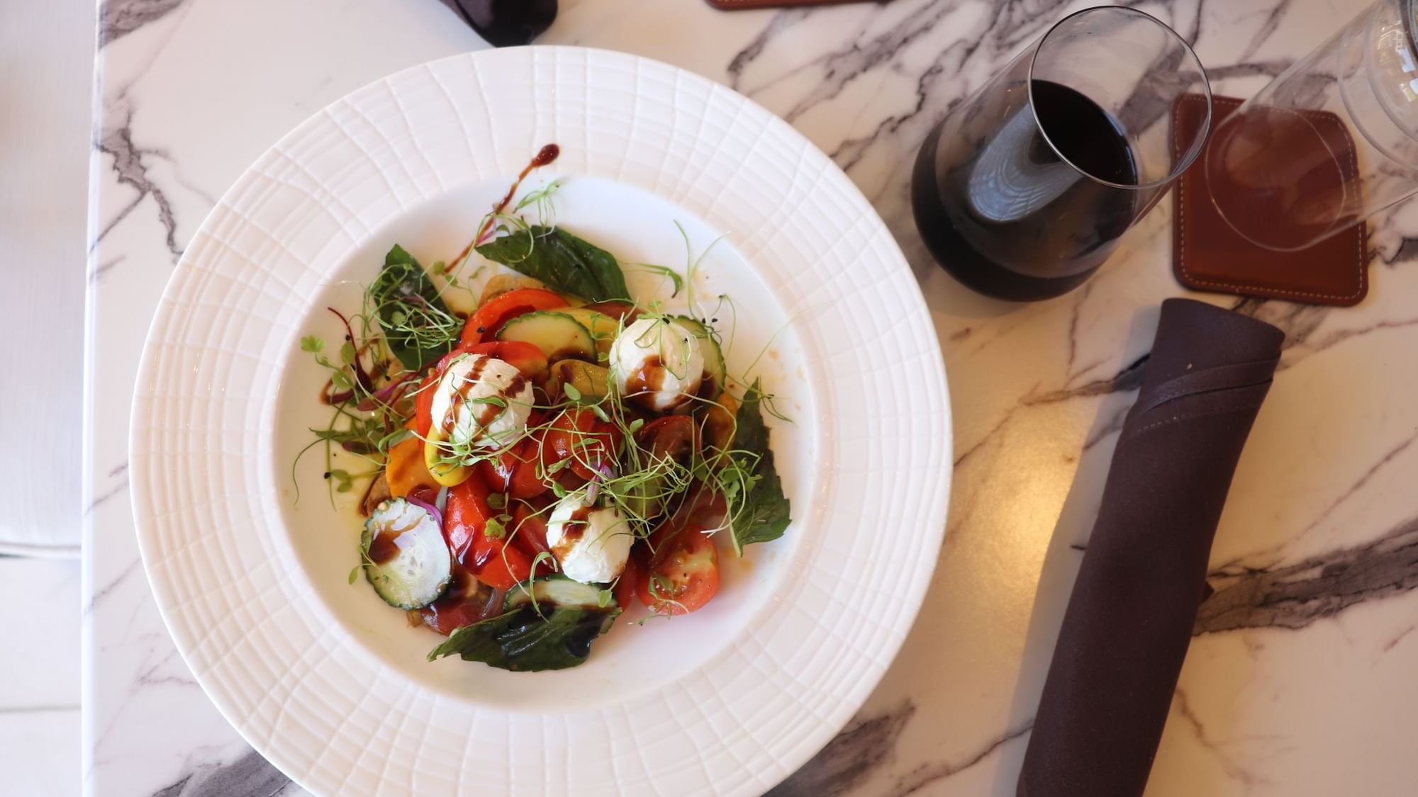 Smoked burrata served on a plate with wine in 1936 at Camp Creek Inn