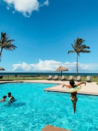 kid jumping into the swimming pool at Waimea Plantation Cottages