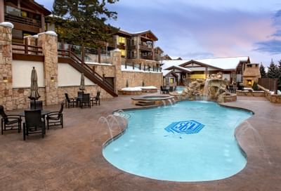 Exterior of the pool with dining area at Stein Eriksen Lodge