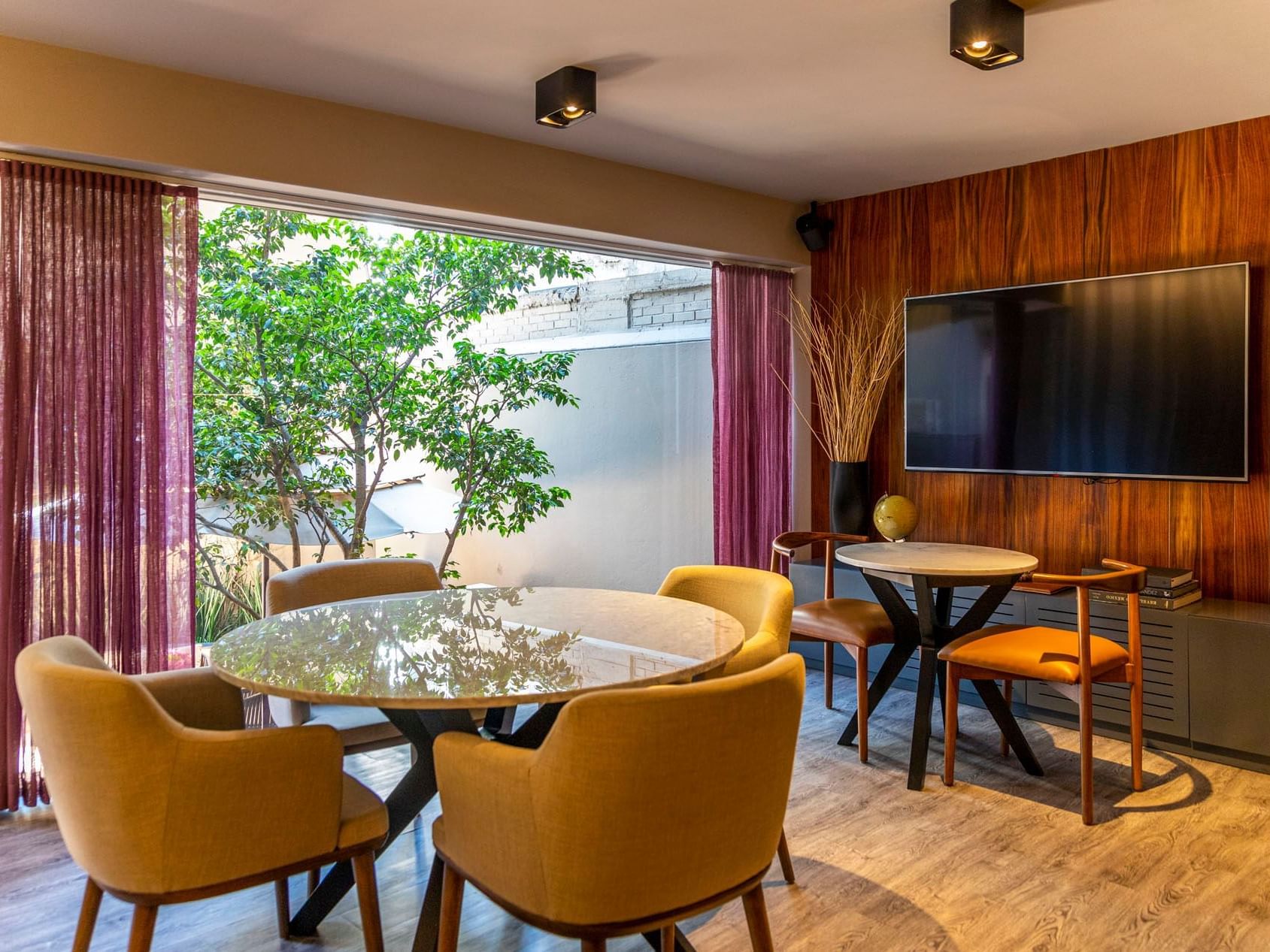 Dining table with TV area, room at Dominion Suites Polanco