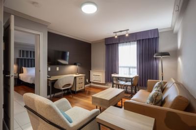 Jacuzzi Suite with living area, open doorway to bedroom at Sandman Hotel & Suites Winnipeg Airport