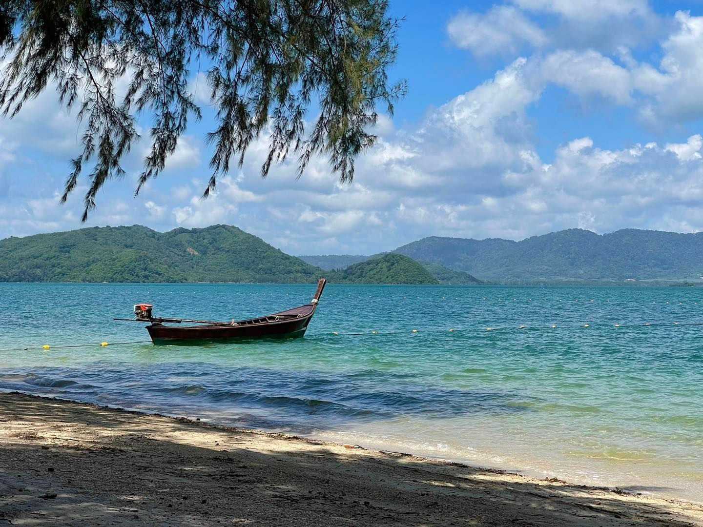 A beautiful beach with lon tailed boat in Lawayai Island (Koh Lawa Yai) - one of the filming locations in Phuket for White Lotus Season 3