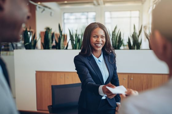 Receptionist giving details for two guests at Sunseeker Resort
