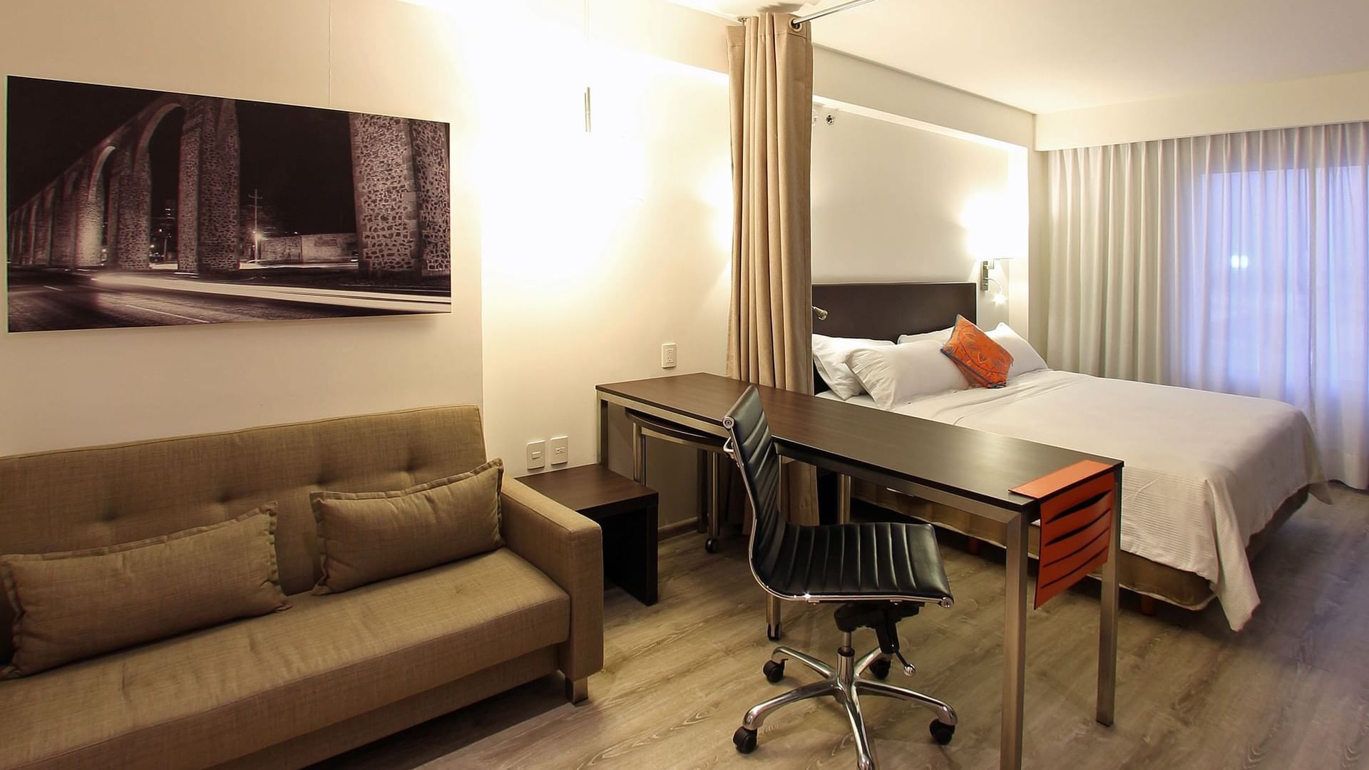 Interior of Loft room with working desk at Fiesta Inn Querétaro