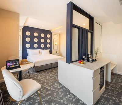 Pictures hung by the king bed in Deluxe Balcony with a coffee station at Eastin Vientiane Laos