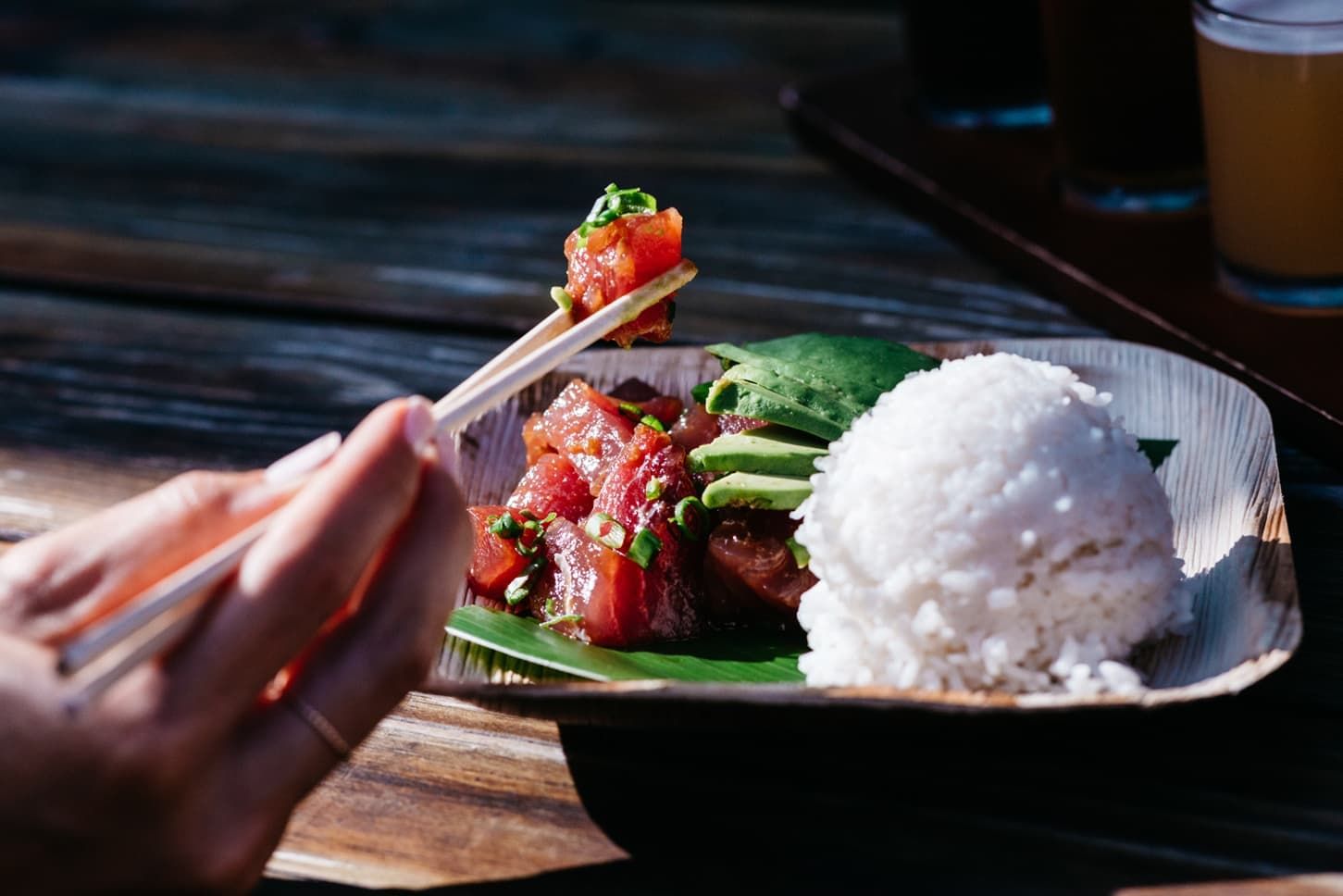 A person having pork with rice dish in Kaka'ako near Waikiki Resort Hotel