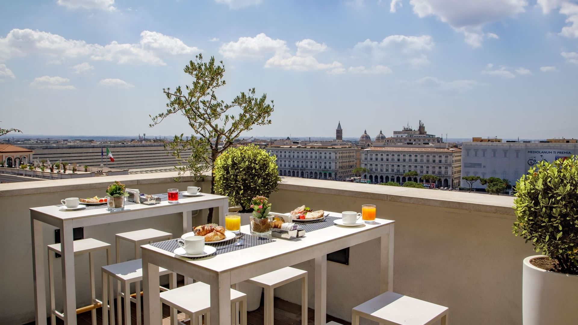Breakfast with a View of Rome, rooftop restaurant with coffee and pastries overlooking Rome at The Independent
