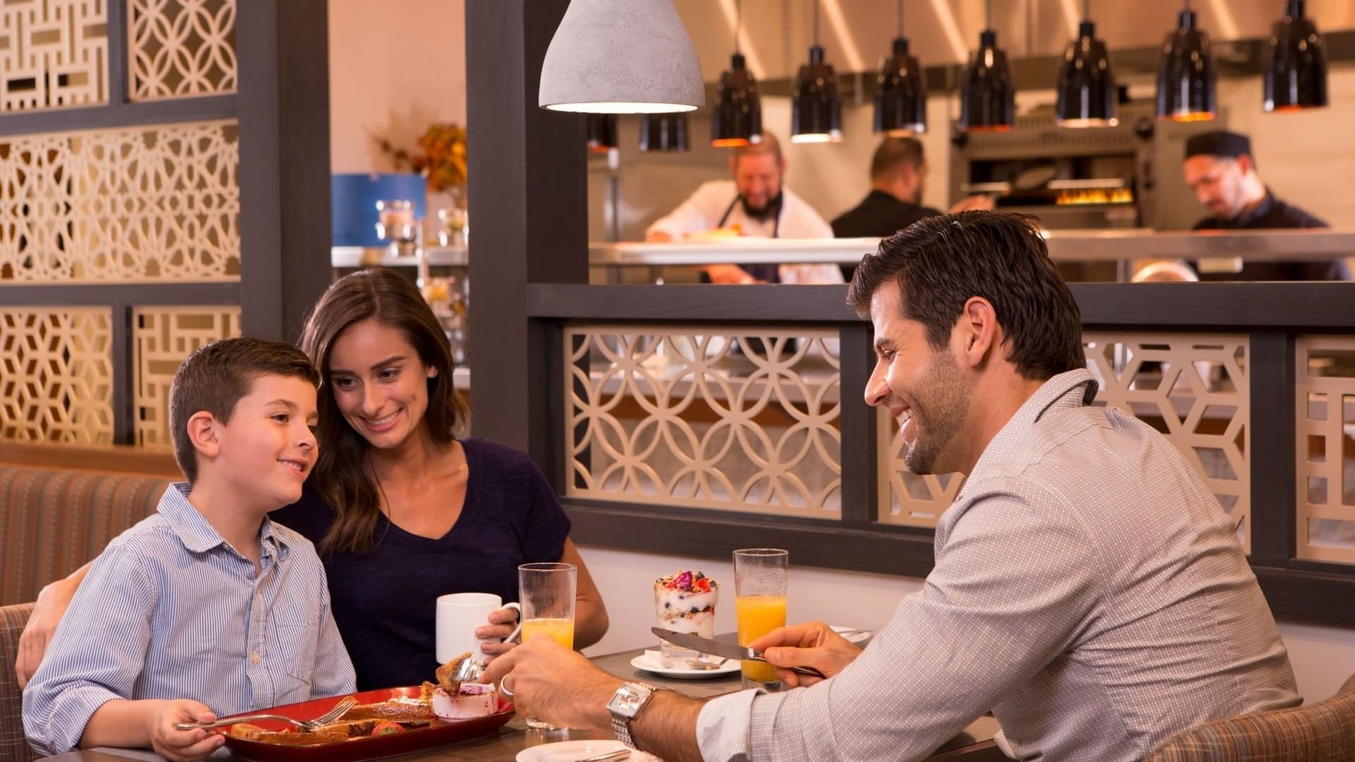 family enjoying a breakfast meal at a restaurant table