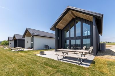 Villas with metal roofs and large glass windows, surrounded by green grass at Off Shore Resort