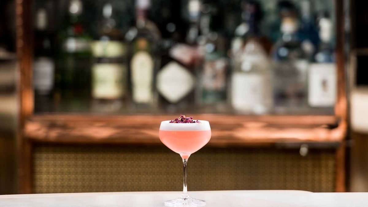 Cocktail with flower garnish on bar counter in TWR at Crown Towers Perth