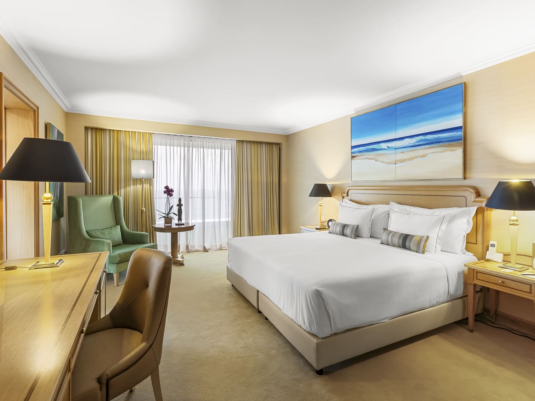 Presidential suite room with large bed, desk, and chairs at Hotel Cascais Miragem Health & Spa in Cascais.