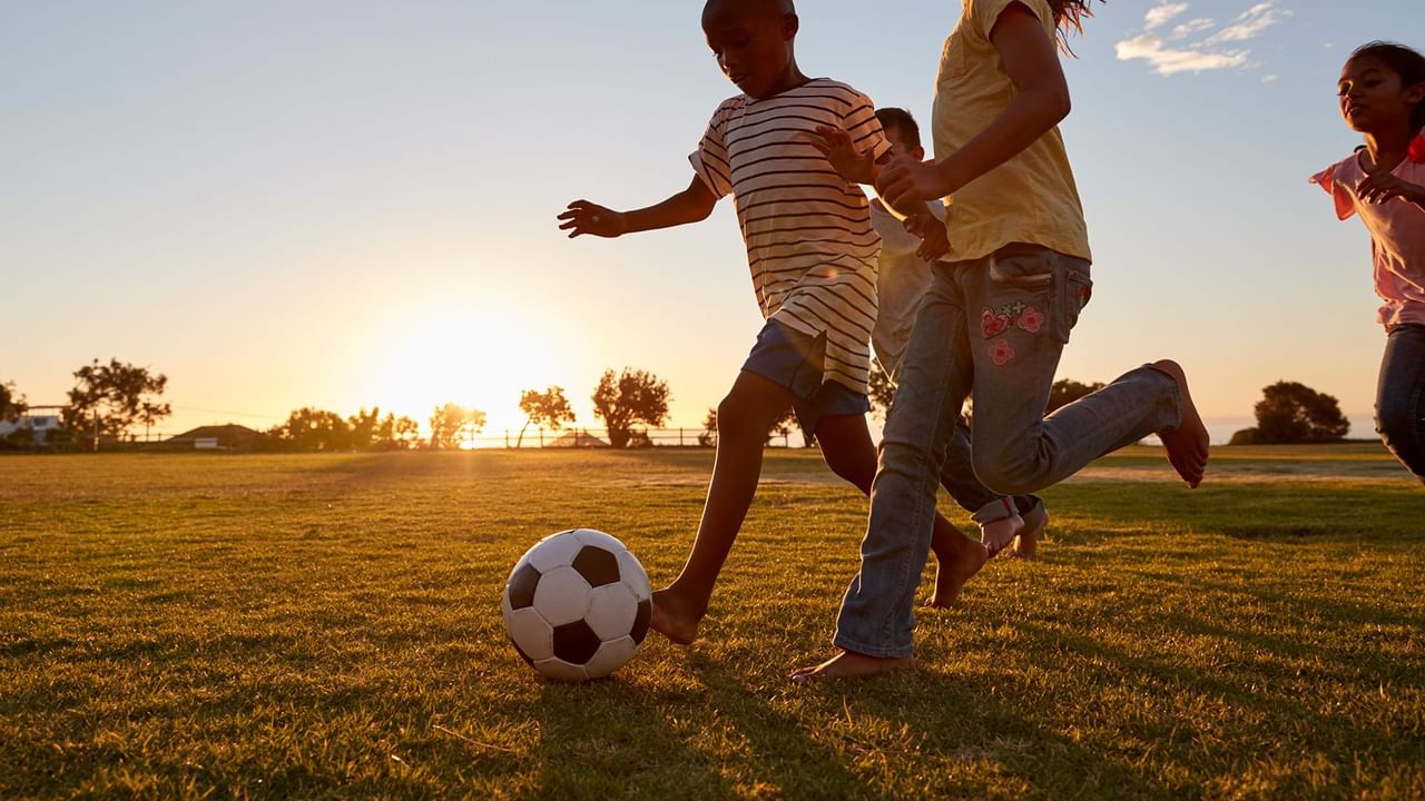children racing after a soccer ball