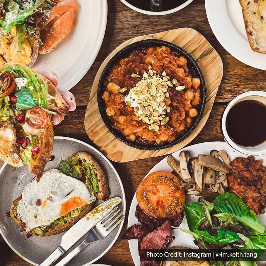 Top view of avocado toast & sides served in a Restaurant near Imperial Lexis Kuala Lumpur