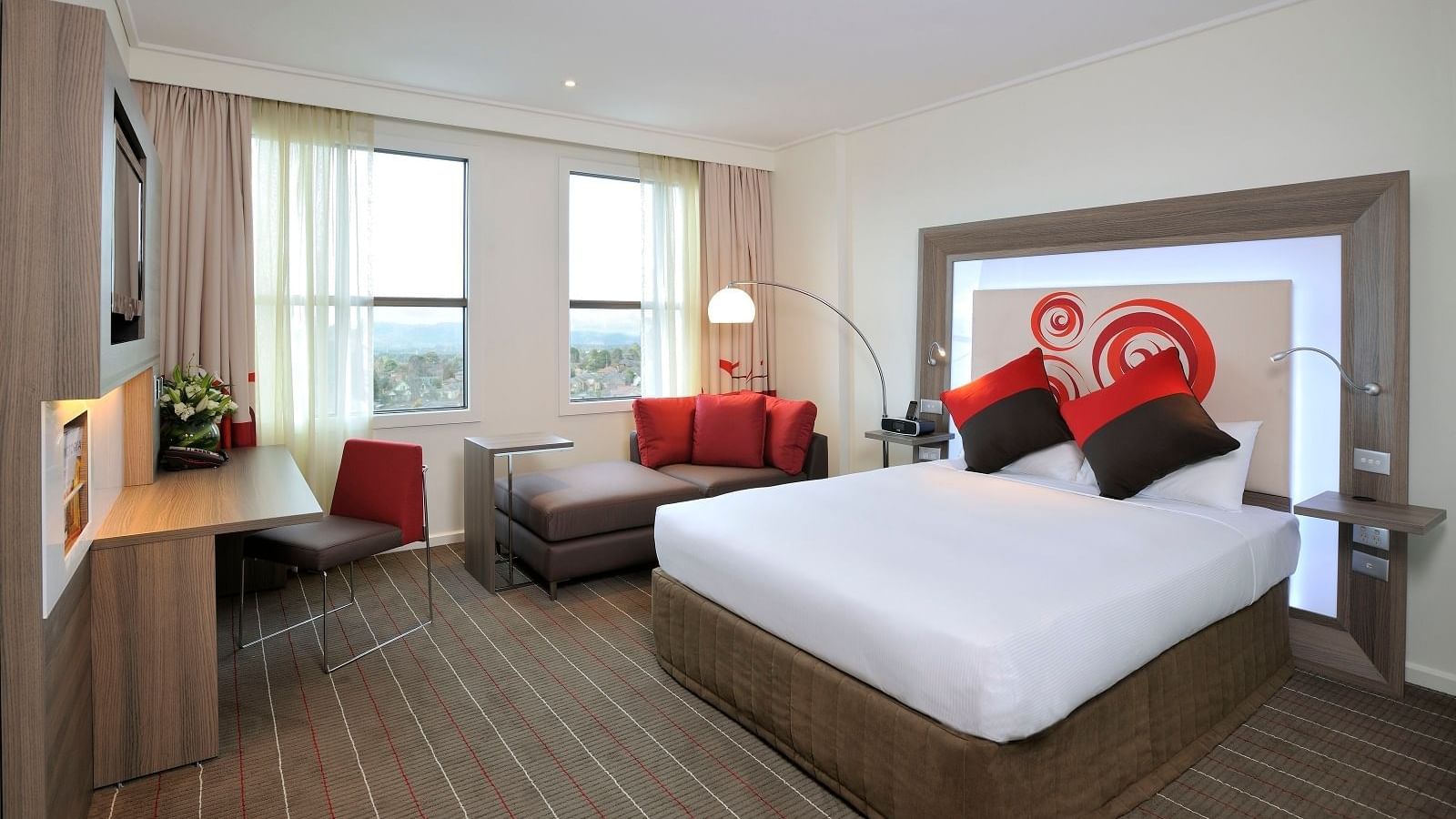 Bed & lounge area in Standard Room at Novotel Glen Waverley