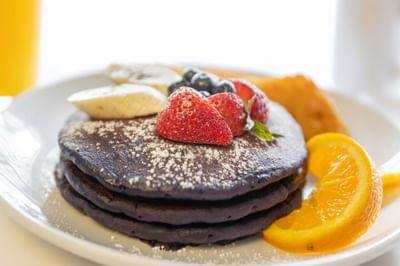 Ube Pancakes with berries served in Ilima Cafe at Waikiki Resort Hotel by Sono