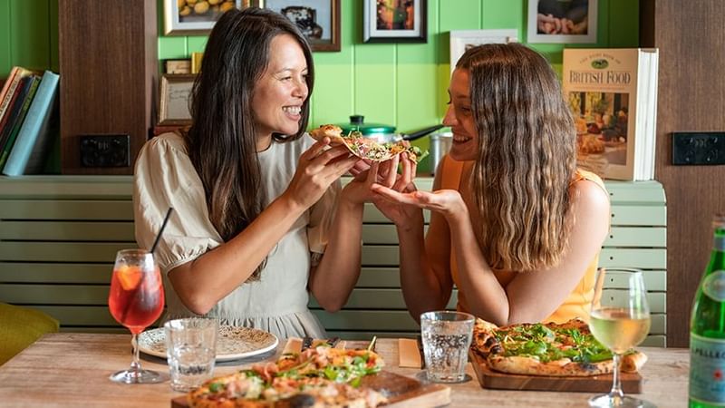 Italian Street Kitchen, two girls eating pizza