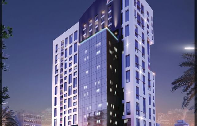 Distant night view of DAMAC Maison Cour Jardin which is one of the 5 stars hotel in Dubai