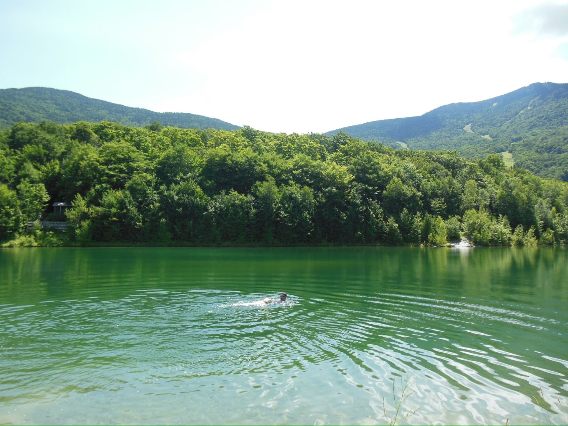 About 15 minutes from Stowe, this hidden Vermont swimming spot offers mountain views and a serene atmosphere. The short hike to this mountainside reservoir is worth it for the cool water and panoramic views of Mount Mansfield.