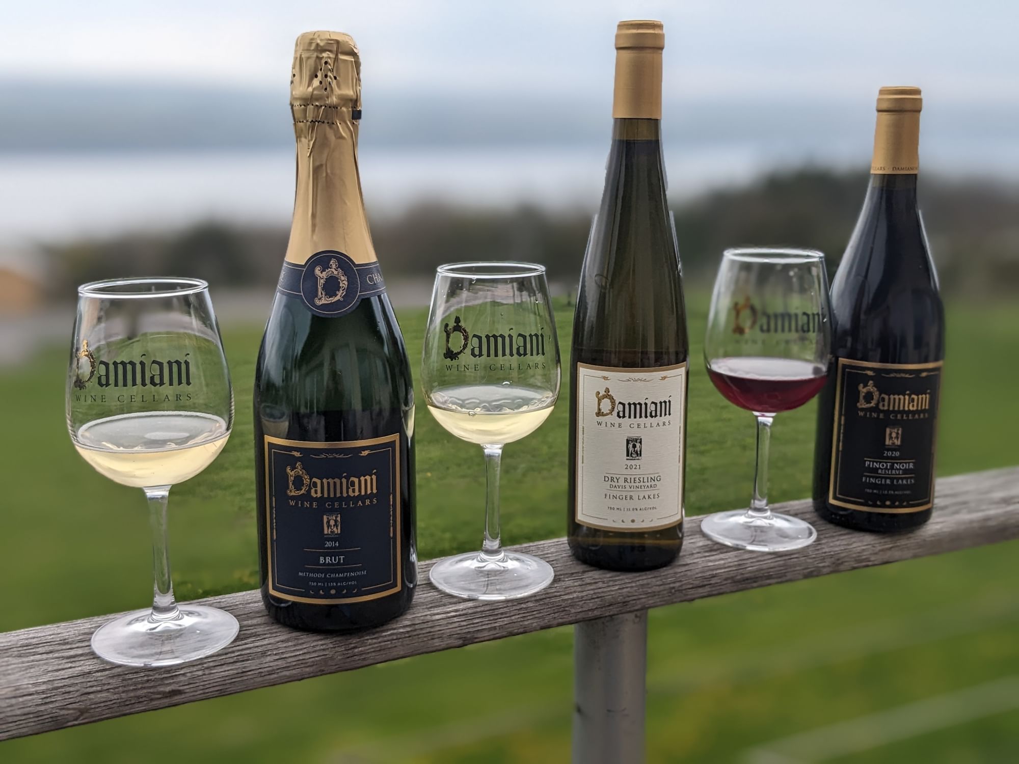 Three Damiani Wine Cellars Tastings stand on a fence at La Tourelle Hotel and Spa