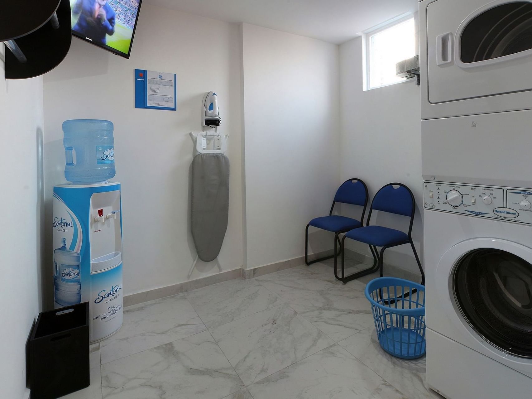 Washing machine, dryer & chairs in Laundry Room at One Hotels