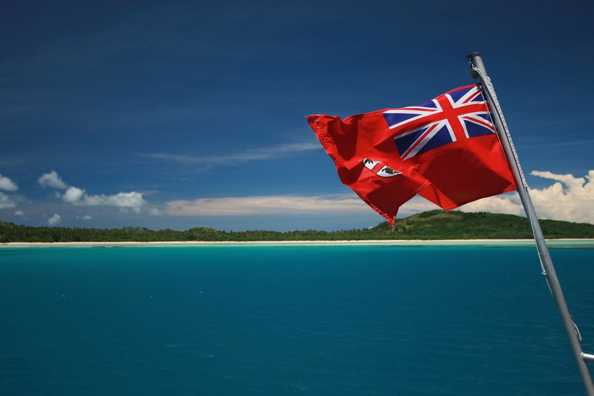 Close-up of the Fiji flag by the ocean near Warwick Fiji