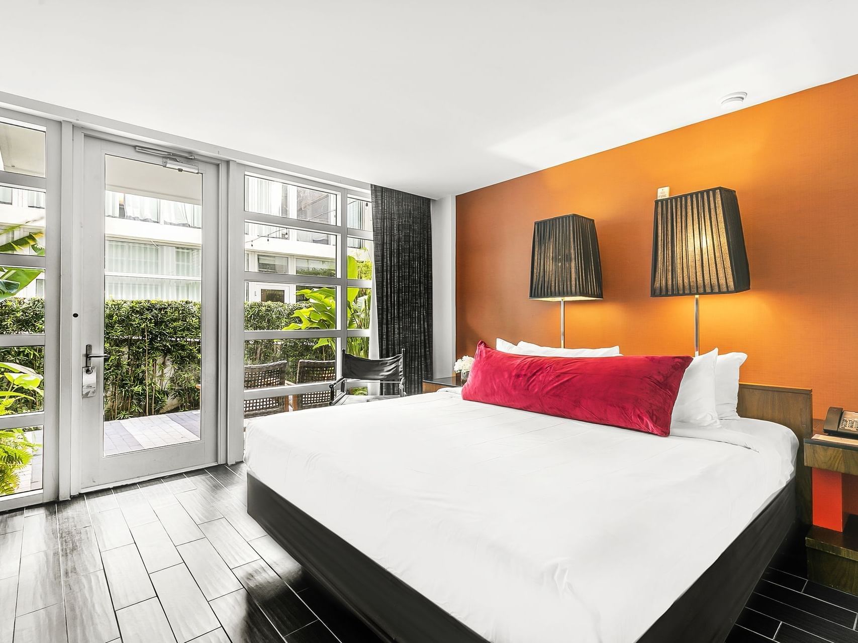 King-size bed with nightstands by the window in Garden Deluxe King at Fairwind Hotel Miami