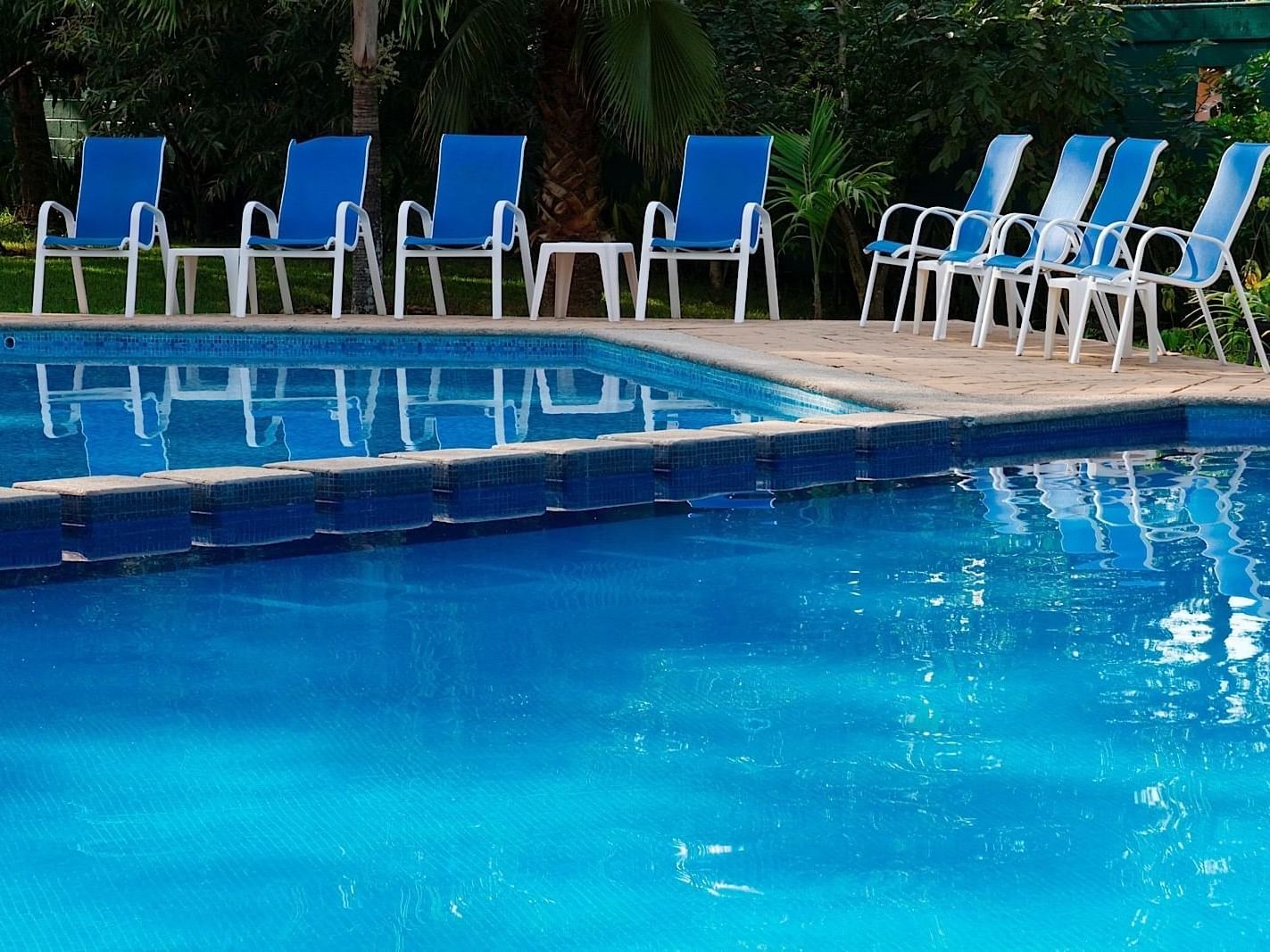 Sunbeds by the outdoor swimming pool at Ciudad Real Palenque